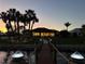 Waterfront home with private dock, landscaped yard, and exterior lighting at dusk at 4450 Northshore Dr, Punta Gorda, FL 33980