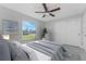 Bedroom featuring a ceiling fan, neutral decor, and a large window at 4492 Kenoska St, North Port, FL 34288