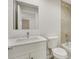Bright bathroom featuring a modern vanity with a large mirror and a shower with marble tile surround at 4517 Meager Cir, Port Charlotte, FL 33948