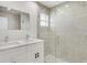 Stylish bathroom vanity featuring double sinks, modern faucets, and a tiled shower at 4517 Meager Cir, Port Charlotte, FL 33948