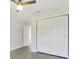Neutral bedroom features a ceiling fan and closet with bi-fold doors at 4517 Meager Cir, Port Charlotte, FL 33948