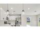 Bright kitchen features white cabinets, stainless steel appliances, and a large island at 4517 Meager Cir, Port Charlotte, FL 33948