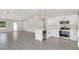Open-concept kitchen with island, stainless steel appliances, and sleek white cabinets at 4517 Meager Cir, Port Charlotte, FL 33948