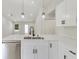 Modern kitchen featuring a central island with stainless steel sink and white cabinets at 4517 Meager Cir, Port Charlotte, FL 33948