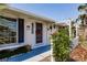 Welcoming front porch featuring a charming white fence, vibrant plants, and unique decor details at 586 Skylark Nw Ln, Port Charlotte, FL 33952