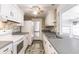 Functional kitchen featuring white cabinets, a tile backsplash, and plenty of counter space at 586 Skylark Nw Ln, Port Charlotte, FL 33952