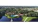 Aerial view of the community showcasing the pool, lake, and lush landscaping, providing a sense of community at 629 Misty Pine Dr, Venice, FL 34292