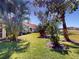 The beautiful backyard is tropical and full of greenery and palm trees at 629 Misty Pine Dr, Venice, FL 34292