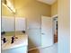 Bathroom boasts modern lighting, ample storage, and a doorway leading to another room at 629 Misty Pine Dr, Venice, FL 34292