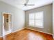Inviting bedroom with hardwood floors, ceiling fan, plantation shutters, and neutral color palette at 629 Misty Pine Dr, Venice, FL 34292