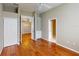 Bedroom featuring hardwood floors, ceiling fan, built-in shelves, and view of connecting rooms at 629 Misty Pine Dr, Venice, FL 34292