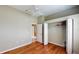 Bedroom features hardwood floors, closet, and view to connecting bath and hallway at 629 Misty Pine Dr, Venice, FL 34292