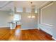 Dining area featuring hardwood floors, stylish lighting, and easy access to the modern kitchen at 629 Misty Pine Dr, Venice, FL 34292