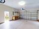 This is a spacious garage with a light colored floor and room for storage and cars at 629 Misty Pine Dr, Venice, FL 34292