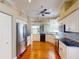 Spacious kitchen with stainless steel refrigerator, black countertops, and an open design leading to outdoor views at 629 Misty Pine Dr, Venice, FL 34292