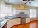 Well-lit kitchen with stainless steel oven and modern appliances, paired with elegant countertop and hardwood floors at 629 Misty Pine Dr, Venice, FL 34292