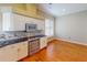 Updated kitchen featuring stainless steel oven and appliances, paired with white cabinets and hardwood flooring at 629 Misty Pine Dr, Venice, FL 34292