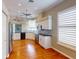 Bright kitchen with stainless steel appliances, white cabinets, and hardwood floors for a modern and stylish look at 629 Misty Pine Dr, Venice, FL 34292