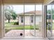 The outdoor lanai has tile floors and a screen door that leads to the back yard at 629 Misty Pine Dr, Venice, FL 34292