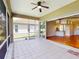The screened in lanai of this home features tile floors and a sliding door to the inside at 629 Misty Pine Dr, Venice, FL 34292