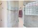 Bathroom with marble shower, glass block window and modern shower head at 629 Misty Pine Dr, Venice, FL 34292