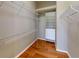 Walk-in closet with wooden floors and plenty of shelving for storage at 629 Misty Pine Dr, Venice, FL 34292
