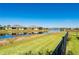 Community pond view behind backyard with neighboring homes across the water at 7081 Waterford Pkwy, Punta Gorda, FL 33950