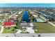 Aerial shot shows home along a canal in a waterfront community with lush greenery and boats docked behind many properties at 740 Via Esplanade, Punta Gorda, FL 33950