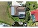 Aerial view showcasing home with a screened-in pool, boat dock and lift, and a well-maintained yard along a canal at 740 Via Esplanade, Punta Gorda, FL 33950