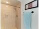 Walk-in shower featuring travertine walls and a rainfall shower head at 740 Via Esplanade, Punta Gorda, FL 33950