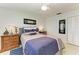 Comfortable bedroom featuring white walls, a ceiling fan and a blue and gray comforter at 740 Via Esplanade, Punta Gorda, FL 33950