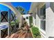 Charming courtyard featuring a fountain, decorative plants, an arched entryway, and a secure metal gate at 740 Via Esplanade, Punta Gorda, FL 33950