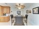 Dining area with a stylish ceiling fan, light wood cabinets, and kitchenware on white countertops at 740 Via Esplanade, Punta Gorda, FL 33950