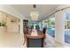 Elegant dining room with a chandelier and view of the pool and outdoor living area at 740 Via Esplanade, Punta Gorda, FL 33950