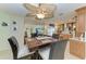 Charming dining area with a unique ceiling fan and view into the kitchen at 740 Via Esplanade, Punta Gorda, FL 33950