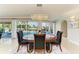 Formal dining area with pool view, modern light fixture, and seating for upscale entertaining at 740 Via Esplanade, Punta Gorda, FL 33950