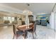 Spacious dining area open to a living space, illuminated by a modern chandelier and natural light at 740 Via Esplanade, Punta Gorda, FL 33950