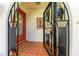 Welcoming front entrance with a decorative gate, tiled flooring, and charming nautical accents at 740 Via Esplanade, Punta Gorda, FL 33950