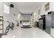 Bright garage with epoxy floors, ample storage, and a sleek white sports car parked inside at 740 Via Esplanade, Punta Gorda, FL 33950