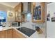 Modern kitchen showcasing a cooktop, stylish range hood, and glass-front cabinets with decor at 740 Via Esplanade, Punta Gorda, FL 33950