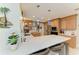 Modern kitchen with white countertops, wood cabinets, stainless steel appliances, and island seating with pendant lighting at 740 Via Esplanade, Punta Gorda, FL 33950