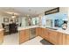 Updated kitchen with stainless steel appliances, wooden cabinets, and white countertops overlooking dining area at 740 Via Esplanade, Punta Gorda, FL 33950