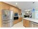 Modern kitchen with stainless steel appliances, custom wood cabinetry, and marble countertops at 740 Via Esplanade, Punta Gorda, FL 33950