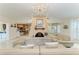 Cozy living room with fireplace, chandelier, and a glimpse into the open kitchen area at 740 Via Esplanade, Punta Gorda, FL 33950