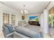 Bright living room with tile flooring, contemporary furnishings, and a large TV for entertaining at 740 Via Esplanade, Punta Gorda, FL 33950
