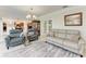 Inviting living room showcasing tile floors, stylish seating, and seamless flow to dining space at 740 Via Esplanade, Punta Gorda, FL 33950