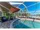 Inviting in-ground pool with screened enclosure, outdoor furniture and gas grill at 740 Via Esplanade, Punta Gorda, FL 33950