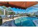 Inviting in-ground pool with screened enclosure, outdoor furniture and gas grill at 740 Via Esplanade, Punta Gorda, FL 33950