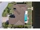 Aerial view of a house with a private pool and dock, surrounded by a well-maintained lawn and landscaping at 8 Ocean Dr, Punta Gorda, FL 33950