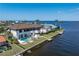 Aerial view of a waterfront home with a private pool, boat dock, and canal access at 8 Ocean Dr, Punta Gorda, FL 33950